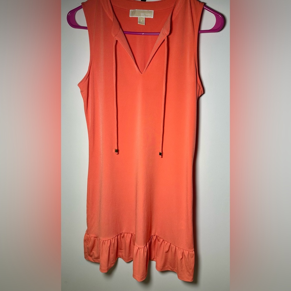 Michael Kors sleeveless dress, front tie with a ruffled hem in bright Coral.
